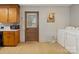 Cozy kitchen with wood cabinets, vintage flooring, and convenient laundry area at 7516 Pageland Hwy # 3, Monroe, NC 28112