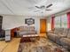 Comfortable living room with ceiling fan, hardwood floors and a door to the exterior at 7516 Pageland Hwy # 3, Monroe, NC 28112