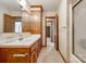 Traditional bathroom with single sink vanity, floral wallpaper, a walk-in shower and wood cabinets at 862 Eastwood Dr, Rock Hill, SC 29730