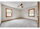 Bright bedroom featuring neutral carpet, natural light from two windows, and ceiling fan at 862 Eastwood Dr, Rock Hill, SC 29730