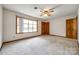 Carpeted bedroom with natural lighting from the large window and two wooden closets at 862 Eastwood Dr, Rock Hill, SC 29730