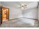 Spacious carpeted bedroom with ceiling fan and doorway to bathroom at 862 Eastwood Dr, Rock Hill, SC 29730