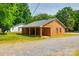 A single story home with brick exterior, gravel drive, covered porch and a green lawn at 862 Eastwood Dr, Rock Hill, SC 29730