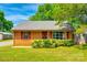 Charming brick home featuring manicured landscaping, red shutters, and a well-maintained lawn at 862 Eastwood Dr, Rock Hill, SC 29730
