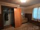 Bedroom featuring neutral wallpaper, a window, closet with doors, and carpeted floors, dated look at 8860 Castor Rd, Salisbury, NC 28146