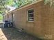 Close up of brick home with window and utilities on the side of house at 8860 Castor Rd, Salisbury, NC 28146