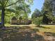 Charming brick home with mature trees and a spacious front yard at 8860 Castor Rd, Salisbury, NC 28146