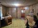 Retro living room showcasing wood paneling and green carpet at 8860 Castor Rd, Salisbury, NC 28146