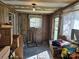 Sun Room with wood paneling, two windows with sheer curtains, and packed boxes at 8860 Castor Rd, Salisbury, NC 28146