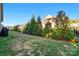 Spacious backyard features lush green grass, privacy trees, and views of the home's exterior at 9565 Horsebit Ln, Concord, NC 28027