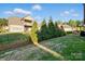 View of backyard features a well manicured lawn and a deck accessible from the house at 9565 Horsebit Ln, Concord, NC 28027