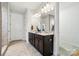 Bright bathroom features a double vanity with marble countertops and modern lighting at 9565 Horsebit Ln, Concord, NC 28027