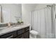 Bright bathroom features a granite countertop, wood cabinets, and a shower-tub combination at 9565 Horsebit Ln, Concord, NC 28027