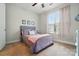 Bright bedroom features a cozy bed and large window with pink curtains at 9565 Horsebit Ln, Concord, NC 28027