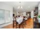 Open-concept dining room features hardwood floors, a chandelier, and access to the kitchen and living areas at 9565 Horsebit Ln, Concord, NC 28027