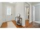 Inviting entryway with decorative table, hardwood floors, and stylish door, leading to other areas of the home at 9565 Horsebit Ln, Concord, NC 28027