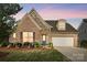 Charming single-Gathering home featuring stone and brick facade and a two-car garage at 9565 Horsebit Ln, Concord, NC 28027