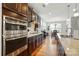 Bright kitchen with stainless appliances, granite countertops, hardwood floors, and an eat-in dining area at 9565 Horsebit Ln, Concord, NC 28027