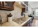 Modern kitchen with granite countertops, gas cooktop, herringbone backsplash, and stainless range hood at 9565 Horsebit Ln, Concord, NC 28027