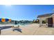 Community pool with lounge chairs and table providing a relaxing area at 9565 Horsebit Ln, Concord, NC 28027
