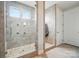 Spacious tiled shower with pebble floor, multiple shower heads and glass door at 9565 Horsebit Ln, Concord, NC 28027