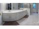 Bright bathroom featuring a double sink vanity, shower, and neutral tile floor at 9600 Lockhorn Ct, Mint Hill, NC 28227