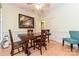 Cozy dining room featuring hardwood floors, wainscoting, and a rustic wooden table at 9600 Lockhorn Ct, Mint Hill, NC 28227