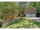 Charming brick home with a two-car garage and a well-maintained lawn with mature trees at 9600 Lockhorn Ct, Mint Hill, NC 28227