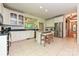 The kitchen features a center island, white cabinets, stainless steel appliances and tile flooring at 9600 Lockhorn Ct, Mint Hill, NC 28227