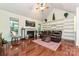 Comfortable living room with a vaulted ceiling, fireplace, built-in shelves, and dark wood flooring at 9600 Lockhorn Ct, Mint Hill, NC 28227