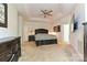Spacious main bedroom with a tray ceiling, ceiling fan, and ensuite bathroom at 9600 Lockhorn Ct, Mint Hill, NC 28227