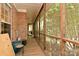 Covered porch with wood flooring and screened in windows showing wooded yard at 9600 Lockhorn Ct, Mint Hill, NC 28227