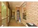Enclosed porch with a brick wall, wooden floor, and large window allowing natural light and outside views at 9600 Lockhorn Ct, Mint Hill, NC 28227