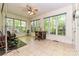 Bright sunroom with large windows offering a view of the surrounding trees and greenery at 9600 Lockhorn Ct, Mint Hill, NC 28227
