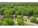 An aerial view showcases houses nestled in a neighborhood surrounded by lush greenery and mature trees at 1007 Doby Springs Dr, Charlotte, NC 28262