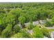 An aerial view showcases houses nestled in a neighborhood surrounded by lush greenery and mature trees at 1007 Doby Springs Dr, Charlotte, NC 28262