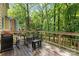 Spacious wooden back deck with outdoor furniture, grill and view of the lush, mature trees at 1007 Doby Springs Dr, Charlotte, NC 28262