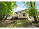 The home's backyard features a wooden deck, shed and lush green lawn at 1007 Doby Springs Dr, Charlotte, NC 28262