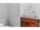 Bathroom features a modern rectangular sink, dark wood vanity, and a round mirror at 1007 Doby Springs Dr, Charlotte, NC 28262