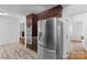Updated kitchen features stainless steel refrigerator and access to an adjacent living space at 1007 Doby Springs Dr, Charlotte, NC 28262