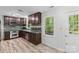 Kitchen showcasing stainless appliances, dark cabinetry, and access to the outdoor deck at 1007 Doby Springs Dr, Charlotte, NC 28262