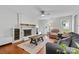Cozy living room with fireplace, natural light, and hardwood floors at 1007 Doby Springs Dr, Charlotte, NC 28262