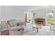 Comfortable living room featuring a piano, armchair, and glass coffee table under natural light at 1007 Doby Springs Dr, Charlotte, NC 28262