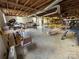 Unfinished basement with exposed beams, ductwork, and workbenches at 1012 Burrage Ne Rd, Concord, NC 28025