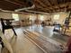 Unfinished basement with exposed beams, ductwork, and several workbenches at 1012 Burrage Ne Rd, Concord, NC 28025