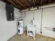 Basement with water heater, utility sink, and updated electrical panel at 1012 Burrage Ne Rd, Concord, NC 28025