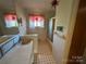 Retro bathroom featuring tile flooring, built-in vanity, and shower with glass doors at 1012 Burrage Ne Rd, Concord, NC 28025