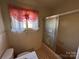 Retro bathroom with window, bathtub with swan art on the glass door at 1012 Burrage Ne Rd, Concord, NC 28025