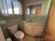 Full bathroom with a green tile backsplash, a toilet, and a vanity with storage at 1012 Burrage Ne Rd, Concord, NC 28025