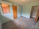 Bedroom with blue walls and carpet flooring, a window, and a view to the outdoors at 1012 Burrage Ne Rd, Concord, NC 28025